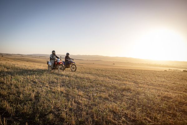 Dr MacPherson on motorbike with community member